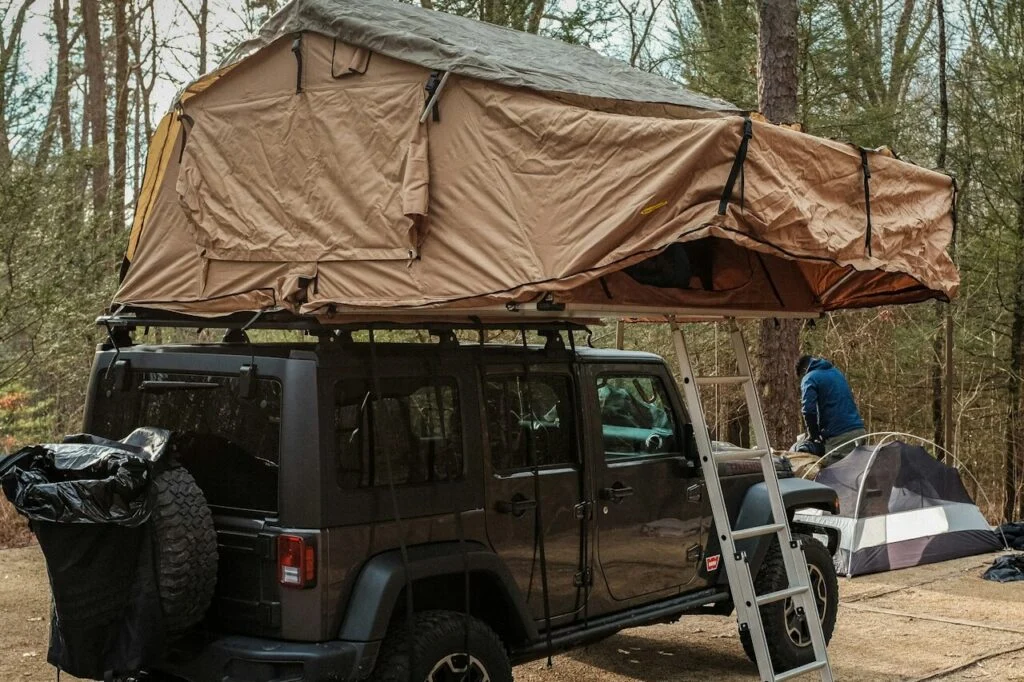 Small pop-up campers designed for subcompact cars showing lightweight towing and compact camping setup